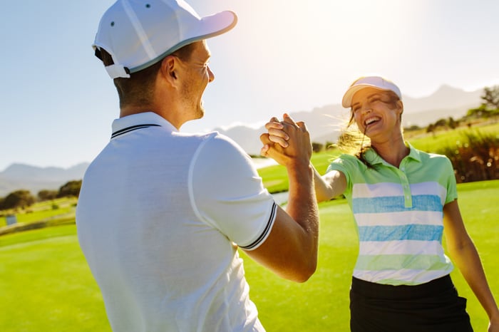 golfers highfiving on course