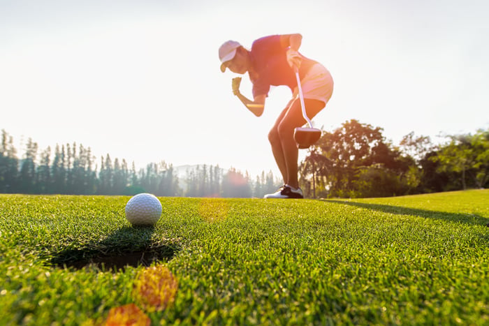 Golfer celebrating a good putt on the green