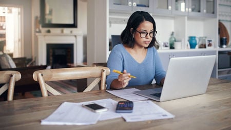 Woman working at desk on computer 